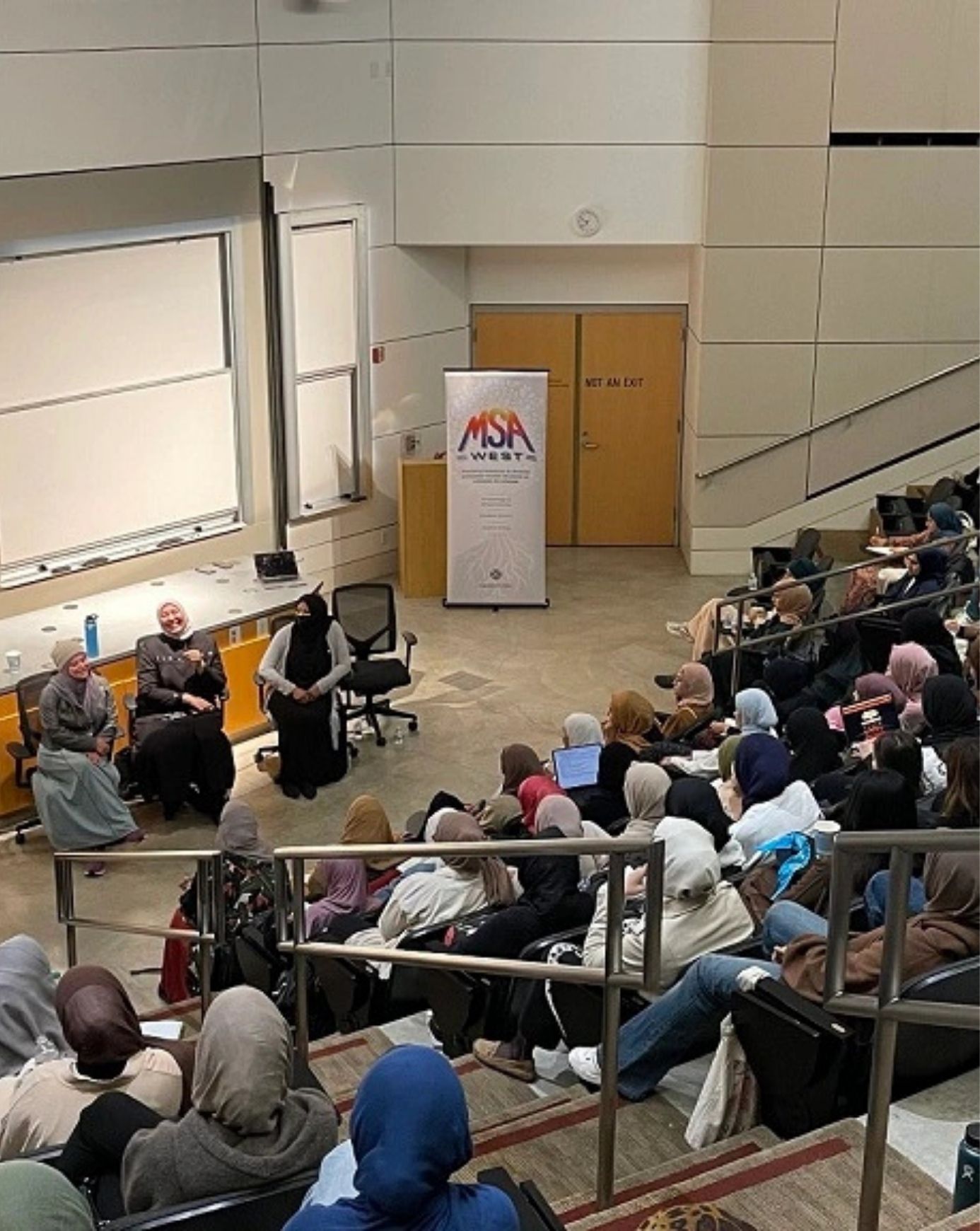 A Maristan panel discussion at an MSA West gathering, with speakers seated before a full audience